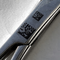 A UDI HIBC Data Matrix barcode etched onto a pair of surgical scissors